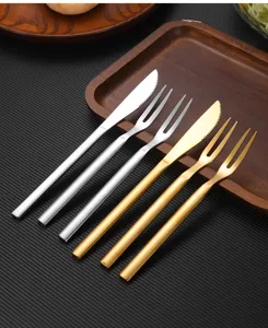 Detailed view of premium golden and silver stainless steel dessert knives and forks set