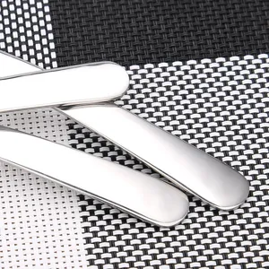 Close-up of polished 304 stainless steel spoon handles on a checkered table mat