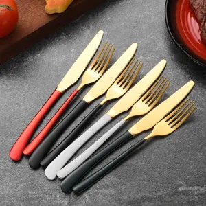 Luxury gold stainless steel cutlery set with colorful handles for an elegant dining table
