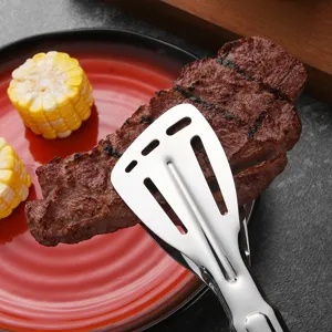 Professional stainless steel BBQ food tongs flipping a grilled steak on a red plate