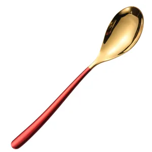 Elegant stainless steel golden spoon with red handle for modern table setting decor