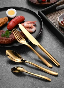 Luxury 4-piece gold stainless steel cutlery set displayed with fine dining food