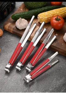 Detail showing stainless steel tongs in various sizes with red plastic handles for BBQ