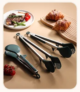 Set of stainless steel kitchen tongs with green silicone tips and standing support
