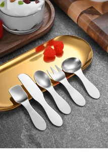 Close-up detail of 5-piece mini stainless steel dessert cutlery set on a decorative gold tray