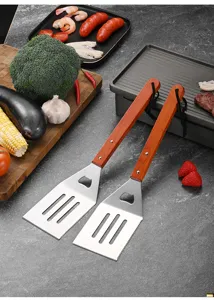 Detailed view of two BBQ spatulas with wooden handles and built-in bottle openers.