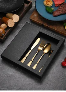 Luxury gold embossed stainless steel cutlery set in a black textured gift box.