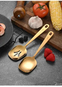 Close-up of elegant gold stainless steel serving and slotted spoons in a kitchen setting