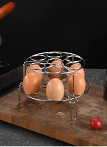Detailed view of 304 stainless steel double-layer egg steamer rack on a wooden board
