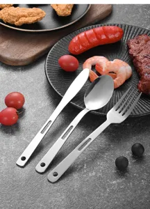 Detailed close-up of a stainless steel knife, fork, and spoon set with hollow handles.