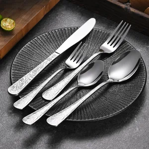Elegant stainless steel cutlery set with vintage embossed floral patterns on handles