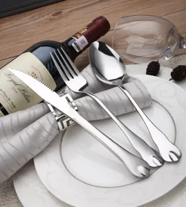 Macro view of polished stainless steel cutlery set with unique water drop design