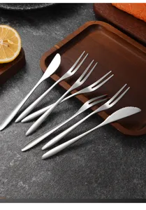 Detail view of 304 stainless steel fruit forks and dessert knives on a wooden tray