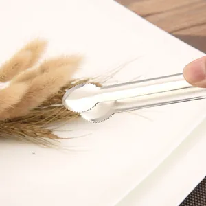Stainless steel food tongs for catering and buffet, shown in hand for kitchen use
