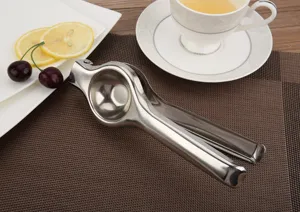 Durable stainless steel manual lemon squeezer on a dining mat with lemon slices