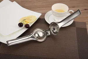 Macro view of an open high-quality stainless steel manual lemon squeezer on a table
