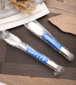 Detail view of two thickened stainless steel BBQ tongs in professional packaging.