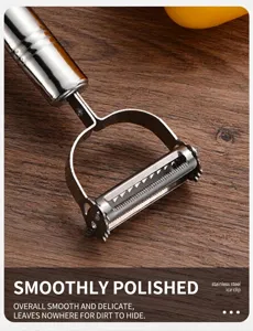 Close-up of polished stainless steel kitchen peeler blade on wood surface
