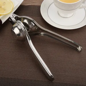Manual stainless steel lemon squeezer and fruit juicer on a brown kitchen placemat.