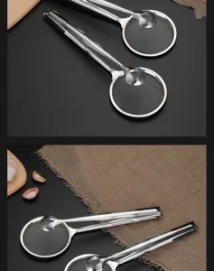 Close-up detail view of stainless steel oil skimmer tongs with fine mesh for frying foods.