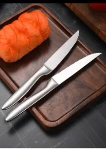 Detailed view of serrated stainless steel steak knives with a premium matte finish