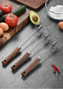 Detailed view of semi-automatic whisks with ergonomic wood grain handles for kitchen baking.