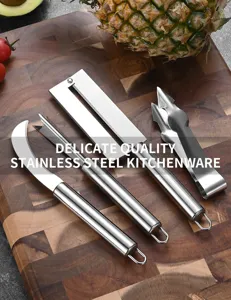 Detail of 4-piece stainless steel pineapple peeler set on a wooden cutting board