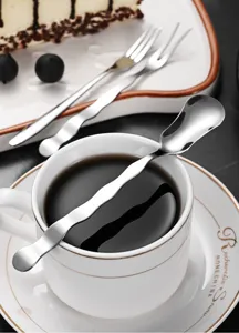 Detailed macro view of a creative stainless steel wavy handle dessert spoon on a coffee cup