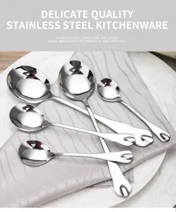 Close-up of stainless steel spoons with unique heart-shaped cutout handle design.