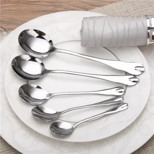Set of five polished stainless steel spoons in various sizes on a ceramic plate