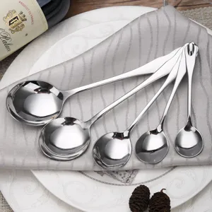 Set of five polished stainless steel round water drop spoons arranged on a napkin