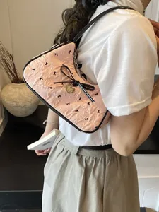 Trendy pink crescent hobo bag for women featuring bow detail and textured pattern