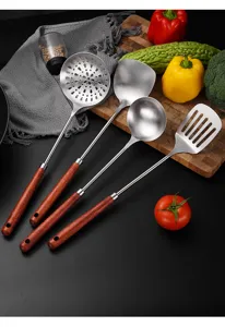 Kitchen utensil set with stainless steel heads and wooden handles in lifestyle setting