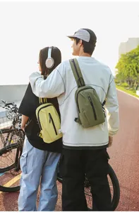 Couple wearing stylish outdoor cycling nylon crossbody chest bags in a scenic park