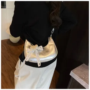 Schicke silberne Metallic-Tasche mit weißer Spitzenschleife und Perlenherz-Detail