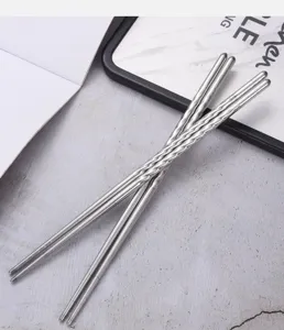 Detailed view of silver stainless steel chopsticks featuring spiral anti-slip handle design