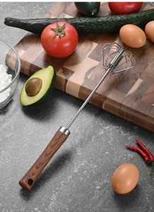 Close-up detail of semi-automatic stainless steel egg whisk with ergonomic wood grain handle
