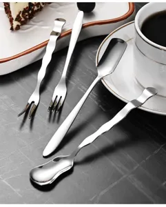 Detailed view of minimalist stainless steel wave-shaped dessert spoon and fork set.