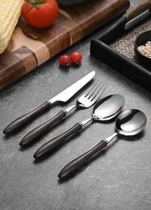 Detailed view of a vintage wenge wood handle cutlery set with polished steel heads