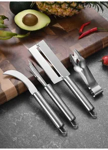 Stainless steel pineapple processing tools including peeler and eye remover on a board