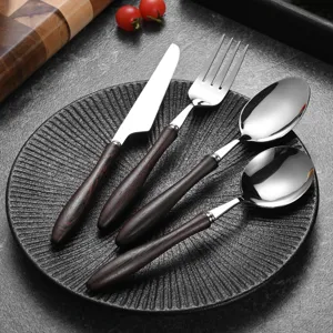 Elegant 4-piece stainless steel cutlery set with wenge wood handles on black plate