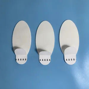 White oval traceless removable adhesive double-sided wall hook detail view showing pull tab