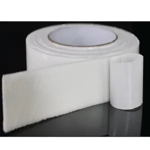 Close-up detail of white double-sided foam tape roll showing strong adhesive sponge texture.