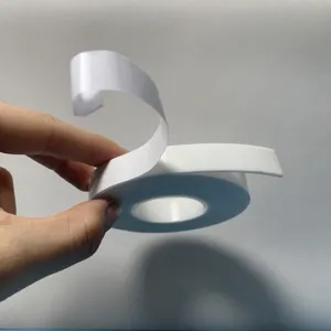 Close-up detail view of strong double sided foam adhesive tape roll, showing white backing layer.