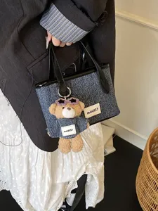 Minimalist denim blue bucket bag for women featuring a cute plush bear bag charm