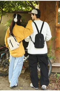 Outdoor lifestyle shot showing the back view of nylon mini chest bags for men and women.