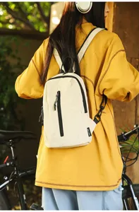Outdoor nylon sling bag for cycling and commuting worn by a model in a park setting