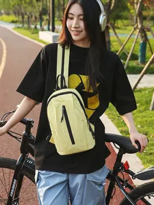 Stylish yellow nylon sling bag shown on a model for outdoor cycling and daily commuting