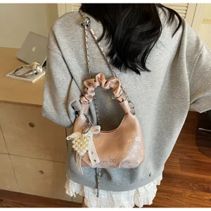 Sac à main plissé élégant orné d'un pendentif raffiné en perles et nœud blanc