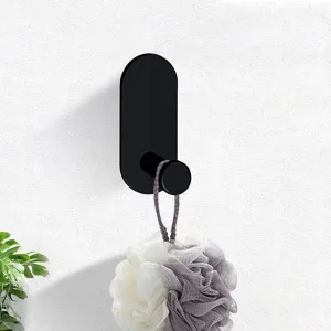 Matte black wall mounted adhesive hook for bathroom, perfect for hanging bath loofahs.